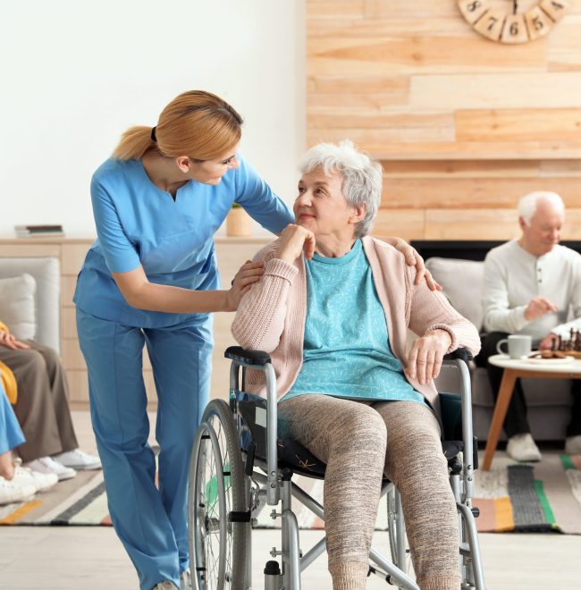 Nurses assisting elderly people at retirement home