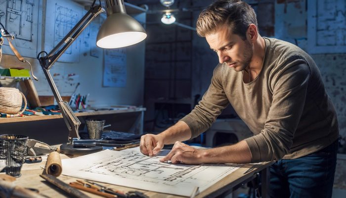 an engineer works late designing a product